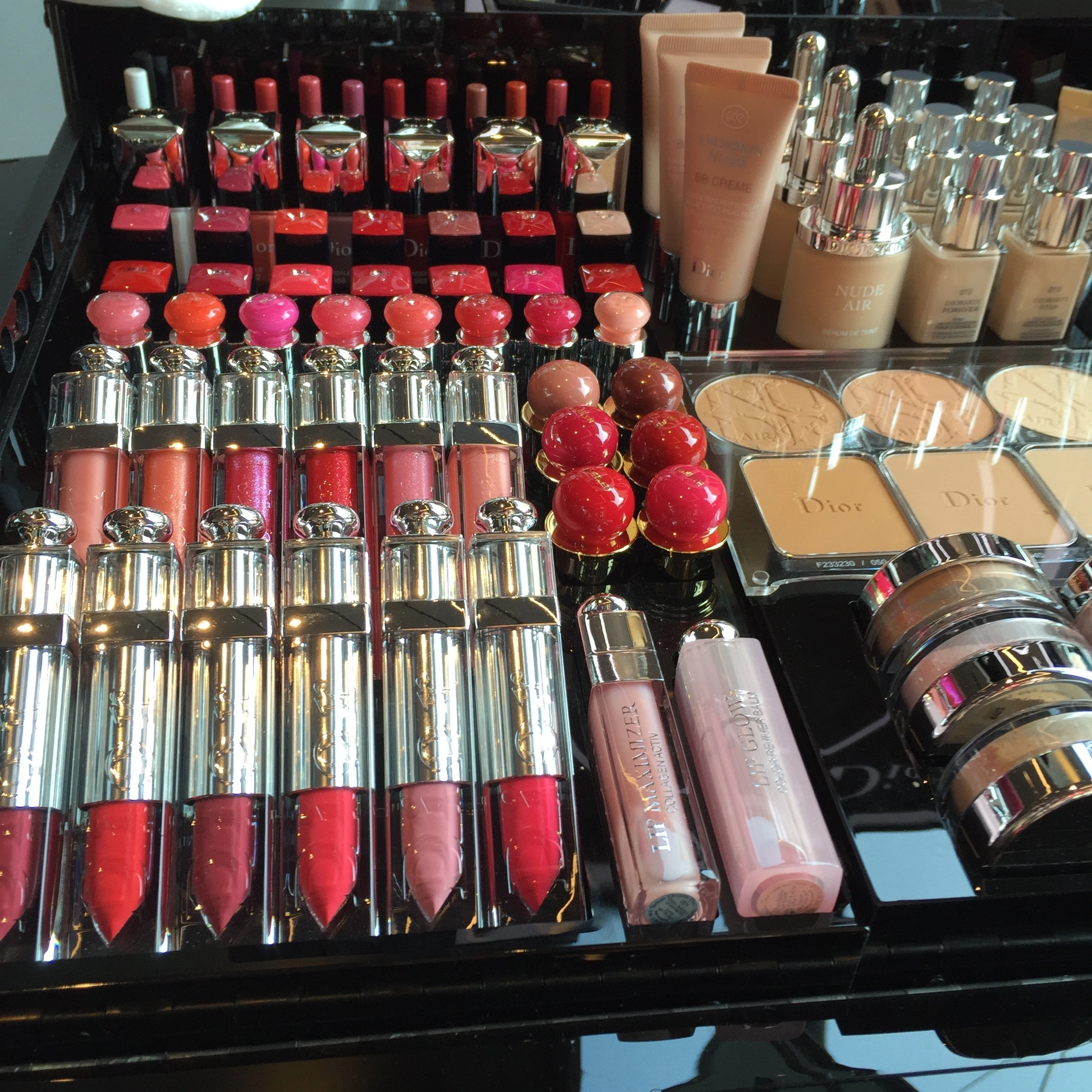 Display of lipsticks, lip glosses, foundation and face powders available for product and shade comparison