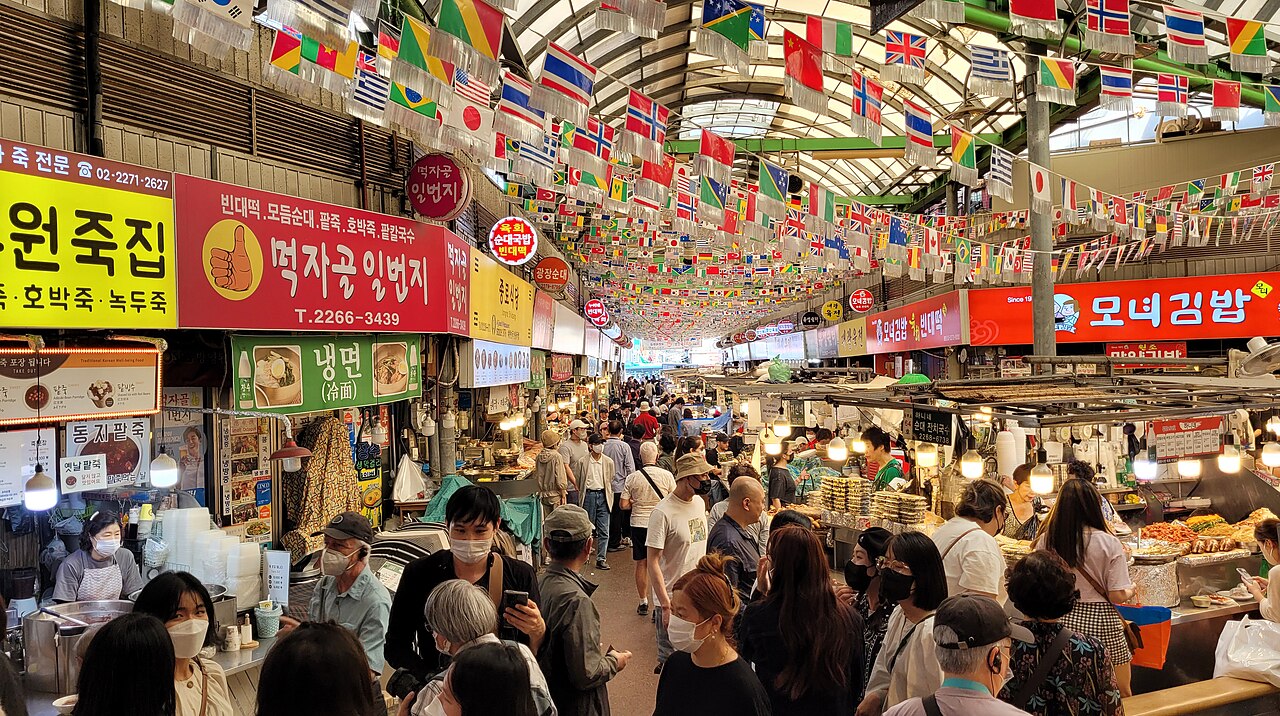 Crowded food stalls inside Gwangjang Market in Seoul